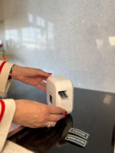 Persona utilizando una rotuladora para crear etiquetas en la cocina.